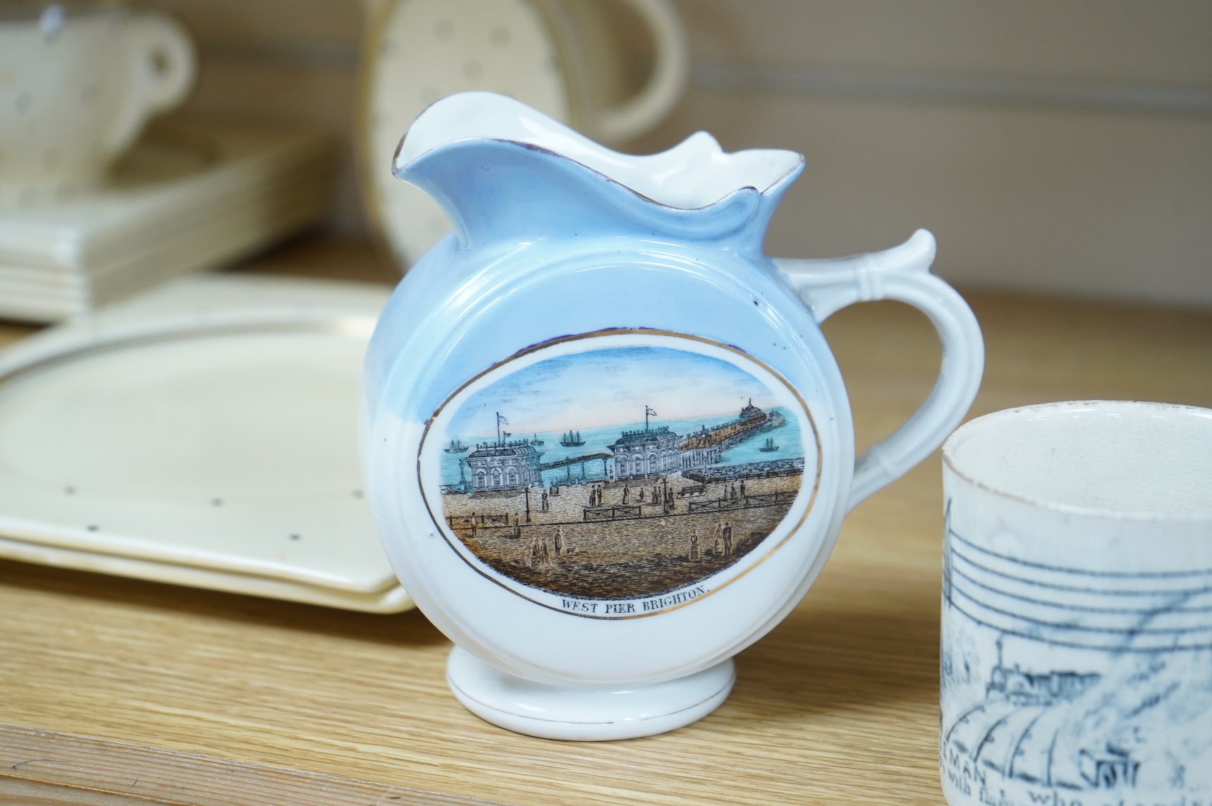 A 19th century Policeman mug and an early 20th century Brighton West Pier jug, 13cm